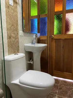 a bathroom with a toilet and a sink and a window at Acantos Hotel Campestre in Támesis