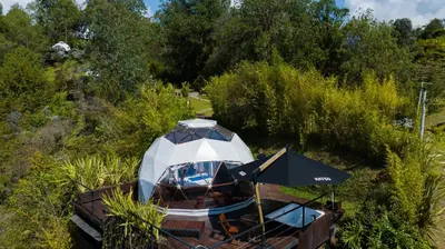 a yurt with an umbrella on a table at Domus Glamping Guatapé in Guatapé