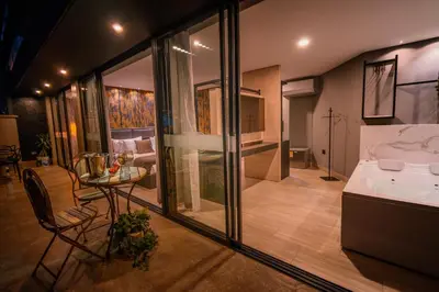 a kitchen and a living room with a table at VPV Suites in Medellín