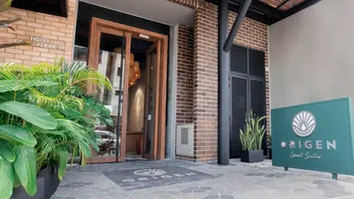 an open door of a brick building with plants at Origen Local Suites in Medellín