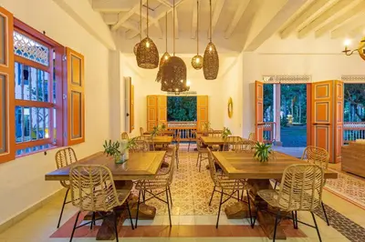 a dining room with wooden tables and chairs at Hotel Boutique Fundadores en Cauca Viejo in Jericó