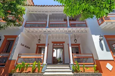 a white house with stairs leading to the front door at Hotel Boutique Fundadores en Cauca Viejo in Jericó