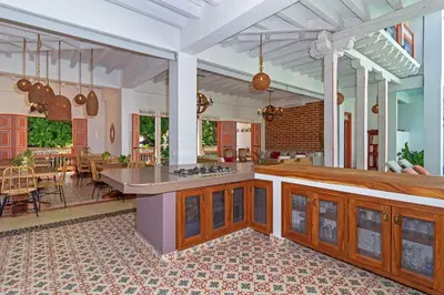 a large kitchen with a stove top island in a house at Hotel Boutique Fundadores en Cauca Viejo in Jericó