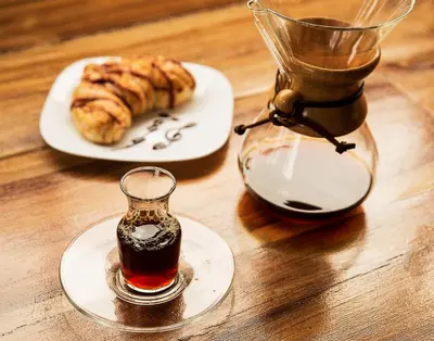 a table with a plate of food and a glass jar at The Coffee Club Apartahotel in Manizales