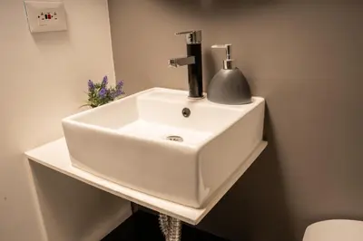 a white sink in a bathroom at The Coffee Club Apartahotel in Manizales