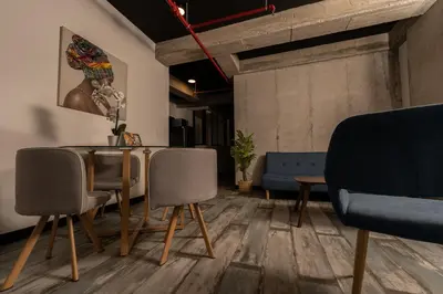 a dining room with a table and two chairs at The Coffee Club Apartahotel in Manizales