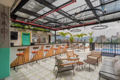a bar on a rooftop with chairs and tables at Masaya Medellin in Medellín