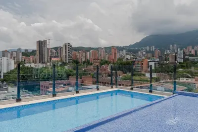 a large swimming pool with a view of a city at Masaya Medellin in Medellín