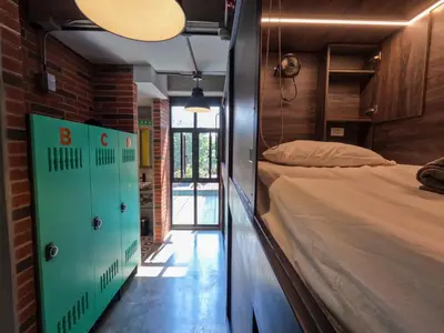 a bedroom with a bed and a door to a room at Masaya Medellin in Medellín