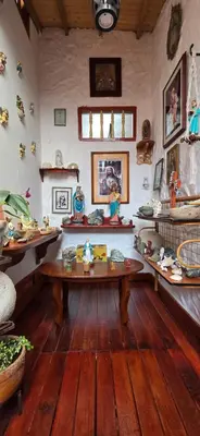 a room with a table and other items on the wall at Casa Patrimonial Abejorral - CASA GASAMA in Abejorral
