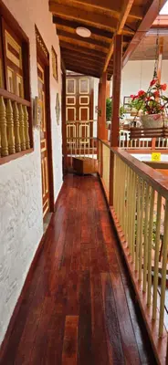 a hallway of a house with a wooden floor and stairs at Casa Patrimonial Abejorral - CASA GASAMA in Abejorral