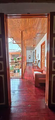 an open door to a living room with a couch at Casa Patrimonial Abejorral - CASA GASAMA in Abejorral