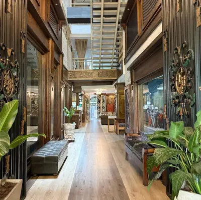 a hallway with plants and furniture in a building at Hotel Du Parc in Medellín