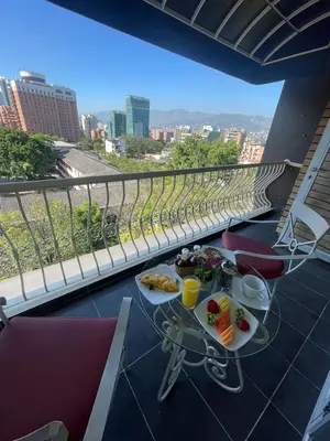 a table with food on top of a balcony at Hotel Du Parc in Medellín