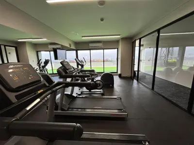 a gym with several treadmills and elliptical machines at York Medellin, Curio Collection by Hilton in Medellín