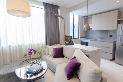 a living room with a couch and a table with purple pillows at York Medellin, Curio Collection by Hilton in Medellín