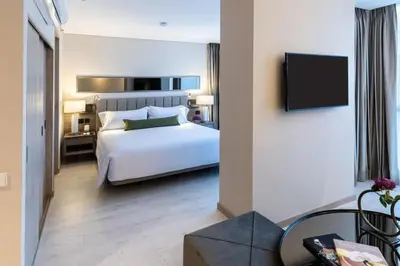 a hotel room with a bed and a tv at York Medellin, Curio Collection by Hilton in Medellín
