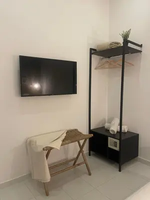 a room with a flat screen tv on a wall at Moet Medellin Hotel in Medellín