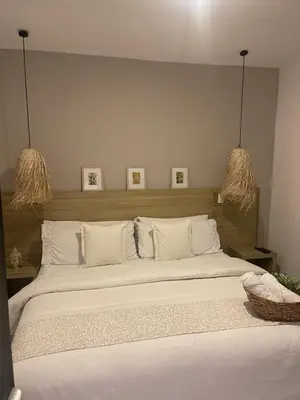 a bedroom with a large bed with white sheets at Moet Medellin Hotel in Medellín