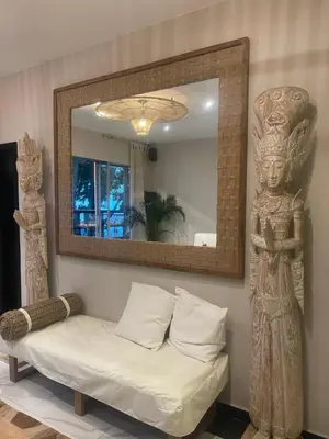 a mirror in a room with a bed and a statue at Moet Medellin Hotel in Medellín