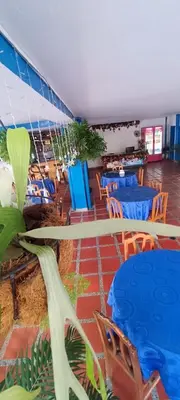 a restaurant with blue tables and blue chairs at HOTEL BRISAS DE SANTA FE in Santa Fe de Antioquia