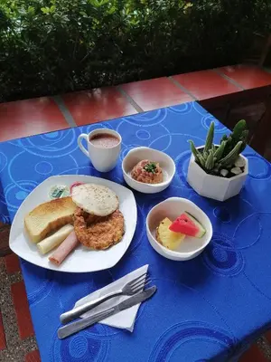 a blue table with plates of food on it at HOTEL BRISAS DE SANTA FE in Santa Fe de Antioquia