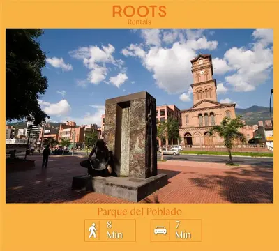 a statue in front of a building with a clock tower at Alojamiento en apartamento cerca a Provenza - M203 By Roots Rentals in Medellín