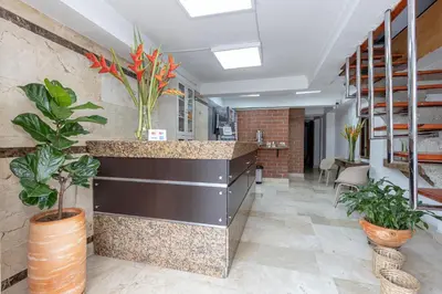 an office lobby with plants and a counter at Gran Caribe Hotel in Medellín