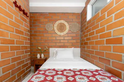 a brick walled bedroom with a bed in a brick room at Gran Caribe Hotel in Medellín