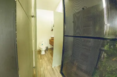 a bathroom with a shower stall and a toilet at Mumu by Bernalo Hotels in Guatapé