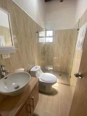 a bathroom with a sink and a toilet and a shower at HOTEL MI CASA DEL NORTE in Santa Rosa de Osos