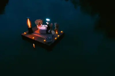 a floating island with candles and a table on the water at Atma Villas - Holistic Wellness Experience in Guatapé