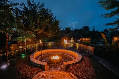 a fire pit in a garden at night at Atma Villas - Holistic Wellness Experience in Guatapé