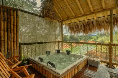 a bath tub in a room with a large window at Atma Villas - Holistic Wellness Experience in Guatapé