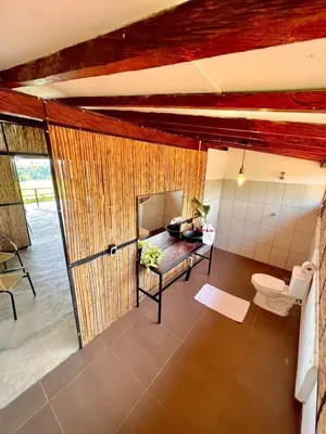 a bathroom with a bed and a toilet in a room at Finca en Doradal ( Hacienda Napoles y Rio Claro ) in Doradal