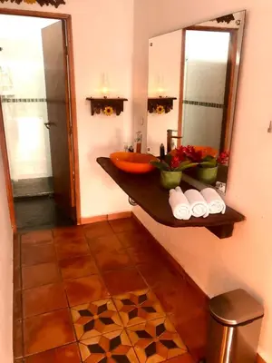 a bathroom with a sink and a mirror at Finca en Doradal ( Hacienda Napoles y Rio Claro ) in Doradal
