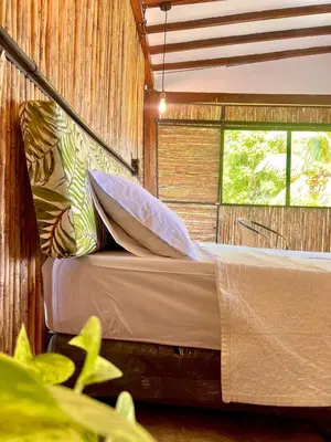 a bedroom with two beds and a window at Finca en Doradal ( Hacienda Napoles y Rio Claro ) in Doradal