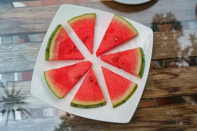 a plate with slices of watermelon on a table at Hotel Boutique las Rosas 5 G in Medellín