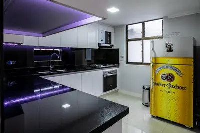 a kitchen with a black counter and a yellow refrigerator at Disfruta de la comodidad como un Hotel 5 Estrellas in Envigado