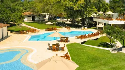 an aerial view of a resort pool with tables and chairs at La Ardilla de Santa Fe by Bernalo Hotels in Santa Fe de Antioquia