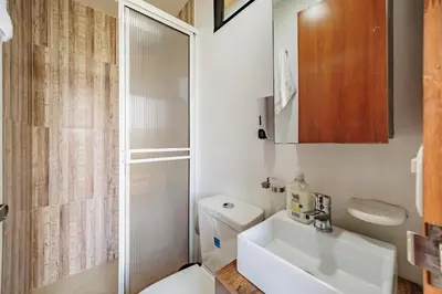 a bathroom with a sink and a toilet and a shower at Pietrasanta hotel campestre frente a la represa del Peñol y Guatape in Guatapé