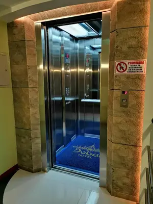 a elevator with a glass door in a building at Hotel Dubai in Manizales