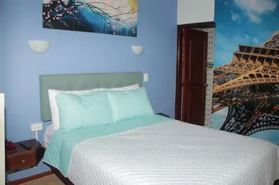 a bedroom with a bed with a picture of the eiffel tower at Hotel Dubai in Manizales