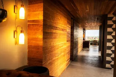 a hallway with wood paneled walls and lights at Cavalta by Bernalo Hotels in Medellín