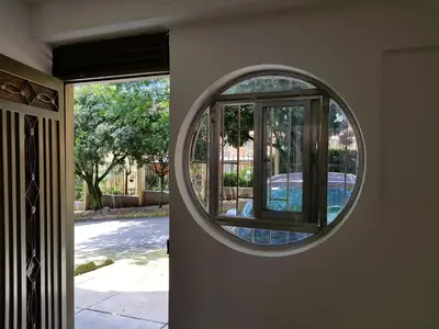 a round mirror on the side of a house at Casa Centro Comercial la Central - Wifi - Outside Parking in Medellín
