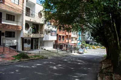 an empty city street with a tree and buildings at Casa Centro Comercial la Central - Wifi - Outside Parking in Medellín