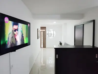 a living room with a flat screen tv on a wall at Casa Centro Comercial la Central - Wifi - Outside Parking in Medellín