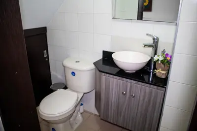 a bathroom with a toilet and a sink at Casa Centro Comercial la Central - Wifi - Outside Parking in Medellín