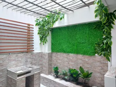 a green wall on the side of a building with plants at Casa Centro Comercial la Central - Wifi - Outside Parking in Medellín