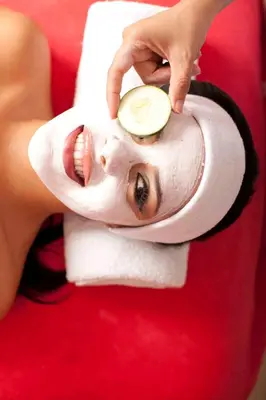 a woman is holding a melon on a mask at Hotel y Spa Santa Fe Colonial in Santa Fe de Antioquia